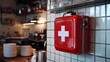 © Adisorn - First Aid Kit Hanging on White Tile Wall in a Restaurant.