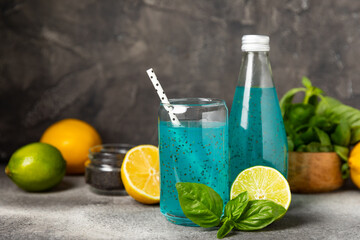 Wall Mural - Diet detox cocktail with basil and chia seeds in a glass jar and a glass on a textured background. Drink with seeds. Health food. Detox cocktail. Antioxidant. Water with basil. Space for text.