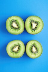 Wall Mural - Cut Kiwi Fruits on Blue Background