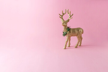 Wall Mural - Gold glitter reindeer on pink background. Minimal New Year composition.