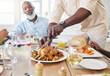 © Flashizzle/peopleimages.com - Chicken, cutting and food with black family in home for Thanksgiving celebration, festive holiday and brunch. Support, love and party with people and lunch for nutrition, grateful and tradition event