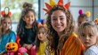 © Nany - A young female teacher and her young students in imaginative carnival costumes, preparing for a Halloween celebration
