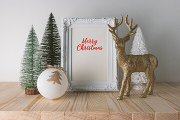 Wall Mural - Holiday concept with Christmas decor and photoframe on wooden table. Creative Christmas or New Year background.