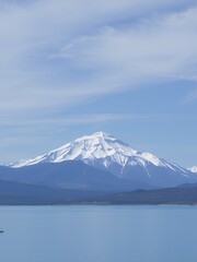 Sticker - A snow-capped mountain peak rises above a calm lake.