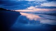 © BerkahStock - A serene beach at dusk, reflecting colorful skies and calm waters.