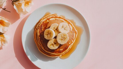 Wall Mural - Pancakes with caramelized bananas and syrup, placed on a pastel peach background for a soft, dreamy breakfast aesthetic