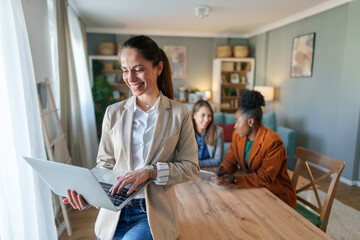 Wall Mural - Confident Businesswoman Working on Laptop at Home