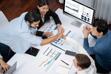 Canvas Print - Diverse group of office employee worker high five after making agreement on strategic business marketing planning. Teamwork and positive attitude create productive and supportive workplace. Prudent