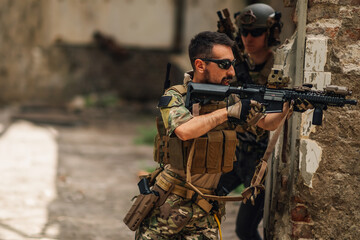 Wall Mural - Few brave soldiers with rifles in action during rescue operation.