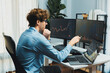 © InfiniteFlow - Young investor in stock trader pointing on dynamic exchange rate on laptop and pc screen in dynamic market graph online in real time at modern home office, analyzing financial technology data. Gusher.