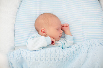 Wall Mural - newborn baby boy in white bassinet