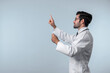 © InfiniteFlow - Side view of smart doctor pointing and checking and looking at chart or application form. Professional doctor diagnosis and analysis medical data while wearing lab coat and stethoscope. Deviation.
