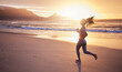 © DavisShared/peopleimages.com - Woman, fitness and running with beach sunset for exercise, cardio or outdoor workout in nature. Young, female person or runner with sunshine for training, sport or physical activity on ocean coast