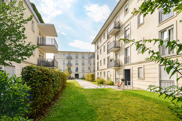 Wall Mural - Residential area with ecological and sustainable green residential buildings, low-energy houses with apartments and green courtyard