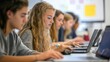 © Elmira - A diverse group of students is intensely working on their laptops, showcasing a collaborative educational environment in a contemporary classroom