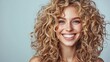 © Ace64 Studio - Blonde woman with curly beautiful hair smiling on gray background.