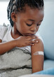 © peopleimages.com - Arm, child and bandage in hospital for vaccine injection, safety or medicine for mpox immunity. African kid, girl or plaster for protection, virus prevention or medical healthcare at pediatric clinic