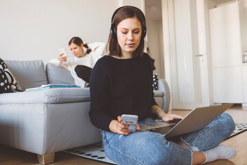 Wall Mural - Young female student having a video online lesson