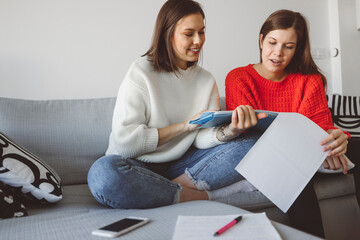 Wall Mural - Two young women studying at home