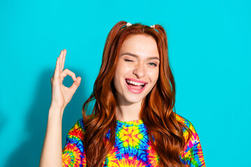 Canvas Print - Photo portrait of attractive young woman wink show okey dressed stylish colorful clothes isolated on cyan color background