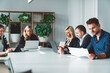 © VisualProduction - Group of colleagues working on laptops and digital tablets in conference room