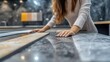 © Generative AI - Asian woman interior designer chooses color of stone countertop for kitchen or facades compare with textile samples Female professional indoor decorator working at showroom or resident : Generative AI
