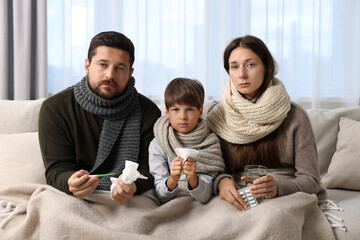 Canvas Print - Cold symptom. Family suffering from fever on sofa at home