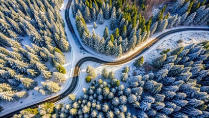 Aerial drone view of a snow-covered winding mountain road through the forest in winter, aerial, drone, view, snowy, winding