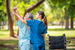 © APchanel - Healthcare or physical therapy nurse is helping elderly woman in performing a stretching or rehabilitation exercise with a resistance band caregiver individuals focused rehabilitation elderly concept.