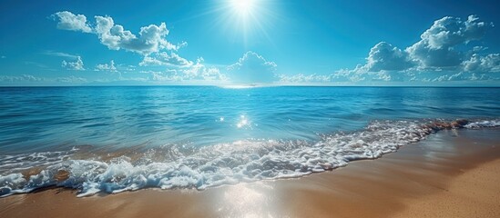 Wall Mural - Tranquil Beachscape with Azure Sky and Sparkling Waves