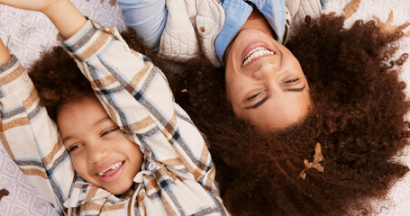 mother, child and happy to relax outdoor on blanket with bonding, autumn fun and together in nature.