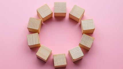 Wall Mural - Wooden blocks arranged in a circular shape on a soft pink background, symbolizing unity, collaboration, and teamwork in business or financial planning. circle formation balance in economic strategy.