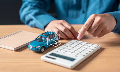 investment, cost, vehicle, automobile, car, agreement, contract, financial, loan, insurance. A person is using a calculator to calculate the cost of a car. The calculator is next to a notebook.