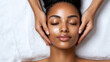 © Hatai - Radiant Woman Receiving Relaxing Facial Massage on White Background