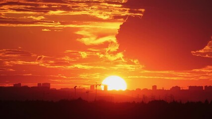 Wall Mural - Sunset over cityscape with cranes and buildings on the horizon, time lapse. City skyline photography for poster, wallpaper, banner, header