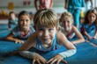 © Alla - A group of children relaxing on a school gym floor, perhaps after physical education or during recess