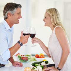 Wall Mural - Mature man, happy woman and wine toast with laugh, love and together for bonding in kitchen. Married couple, celebration and cheers with alcohol for healthy meal, nutrition or romantic dinner in home