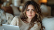 © feeling lucky - A young woman relaxing on a cozy sofa, using a laptop and enjoying a comfortable home environment.