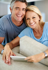 Poster - Lounge, portrait and couple with tablet, happy and watch of movie, romance and subscription for entertainment. House, man and woman with app, streaming and smile in living room, break and affection