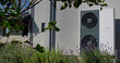 © StockMediaSeller - Outdoor heat pump unit with lavender plants in a modern garden setting, with a house in the background.