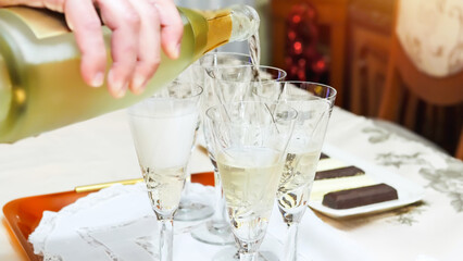 Pouring Champagne into Glasses for Celebration