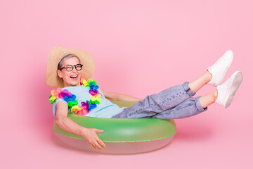 Poster - Full size photo of pretty aged woman sit inflatable ring isolated on pink color background