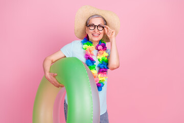 Canvas Print - Photo of pretty aged woman inflatable ring touch glasses empty space isolated on pink color background