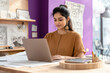 © PIX OF WORLD AI - young indian woman working on laptop