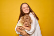 © sementsova321 - Cheerful positive mom and preschooler little girl embracing on yellow background child with mother expressing happiness and joy while sharing tender moments