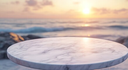 Poster - A marble table stands by the ocean at sunset, creating a serene and inviting atmosphere.