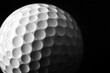 © SRENStock - A white golf ball on a tee against a black background