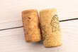 © Oleksandr - Two wine corks on a wooden table, macro, top view.