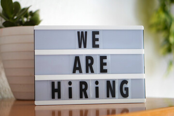 We are hiring. sign on light box. job hiring concept