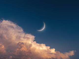 Wall Mural - young moon in the sky at sunset. big moon above the clouds. celestial landscape.